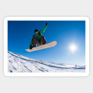 Snowboarder jumping against blue sky Sticker